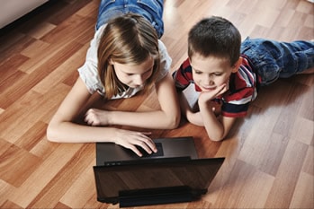 Children playing games in laptop.
