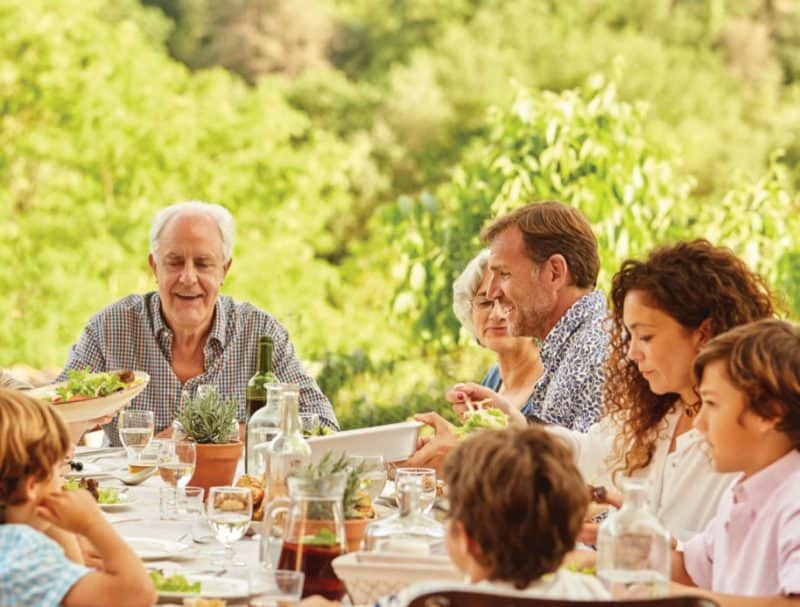 Why Choose a Family Office? Family eating outside.