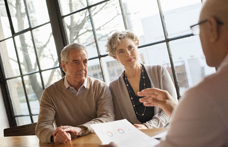 A close up shot of three people having conversation.