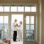 An elegant shot of a man and a woman on the balcony.