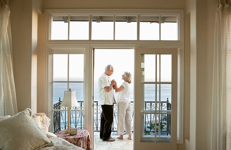 An elegant shot of a man and a woman on the balcony.
