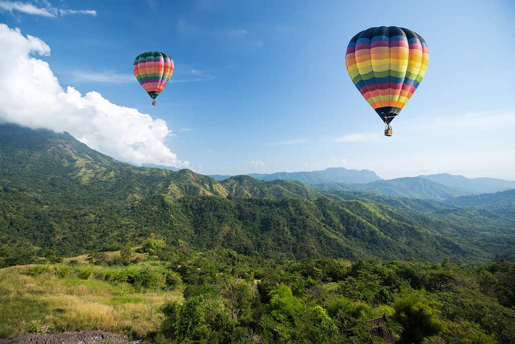 Hot air balloon over mountain landscape