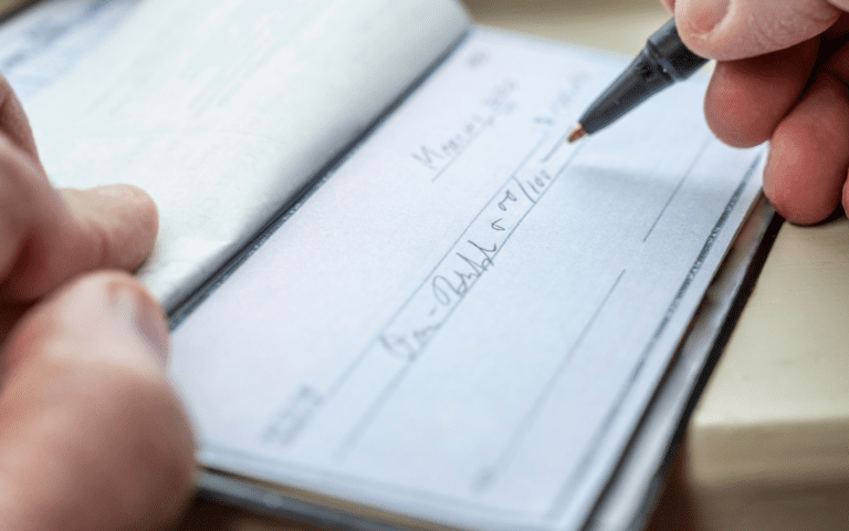writing check for charity giving after a liquidity event