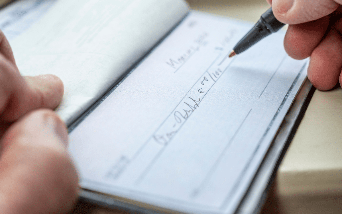 writing check for charity giving after a liquidity event