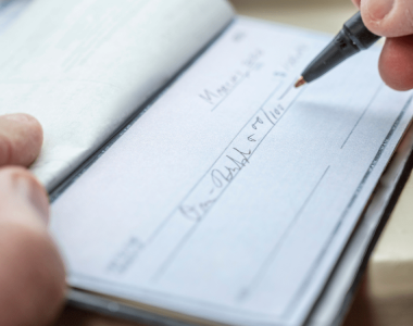writing check for charity giving after a liquidity event